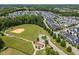Overhead shot of a large neighborhood with a baseball field, trees, and rows of houses at 450 Granite Mill Blvd, Chapel Hill, NC 27516