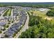 Panoramic aerial view of a neighborhood with lush trees and a distant school building at 450 Granite Mill Blvd, Chapel Hill, NC 27516