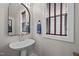 Stylish half-bath with a pedestal sink, modern faucet, and window with wooden blinds at 450 Granite Mill Blvd, Chapel Hill, NC 27516