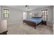 Spacious bedroom with natural light and neutral colors, featuring a large bed and carpeted floor at 450 Granite Mill Blvd, Chapel Hill, NC 27516