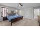 Well-lit bedroom with carpet flooring, ceiling fan, wood blinds, and closet doors at 450 Granite Mill Blvd, Chapel Hill, NC 27516