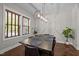 Bright dining room features hardwood floors, modern lighting, a dining table with seating for six, and natural light at 450 Granite Mill Blvd, Chapel Hill, NC 27516