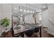 Open-concept dining room with modern lighting, a dark wood table with seating for six, and hardwood flooring at 450 Granite Mill Blvd, Chapel Hill, NC 27516