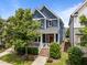 Charming two-story home with blue siding, a red front door, a cozy front porch and landscaped front yard at 450 Granite Mill Blvd, Chapel Hill, NC 27516