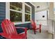 Inviting front porch with red Adirondack chairs and lovely window views at 450 Granite Mill Blvd, Chapel Hill, NC 27516