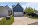 Exterior image of a navy-blue house with a white garage door and a concrete driveway at 450 Granite Mill Blvd, Chapel Hill, NC 27516