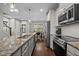 Bright kitchen with stainless steel appliances, a large granite island, and hardwood floors at 450 Granite Mill Blvd, Chapel Hill, NC 27516