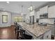 Spacious kitchen featuring a granite island with barstool seating, white cabinets, and stainless steel appliances at 450 Granite Mill Blvd, Chapel Hill, NC 27516