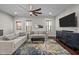 Cozy living room with a ceiling fan, large windows, and a comfortable sectional sofa at 450 Granite Mill Blvd, Chapel Hill, NC 27516