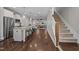 Open-concept living space with hardwood floors, a kitchen island, stairs, and a living room at the end at 450 Granite Mill Blvd, Chapel Hill, NC 27516