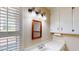 Well-lit bathroom with a vanity sink, classic fixtures, and window allowing natural light to filter through at 4509 Stevens Chapel Rd, Smithfield, NC 27577
