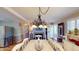 Charming dining area adjacent to the living room with a fireplace, decorative chandelier, and access to the deck at 4509 Stevens Chapel Rd, Smithfield, NC 27577