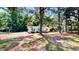 Landscaped front yard with mature trees surrounding a well-maintained single-story home at 4509 Stevens Chapel Rd, Smithfield, NC 27577
