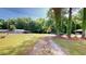 Driveway and multiple buildings situated among a green lawn and numerous trees at 4509 Stevens Chapel Rd, Smithfield, NC 27577