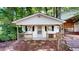 Exterior view of house with wood porch and siding and wooded yard at 4509 Stevens Chapel Rd, Smithfield, NC 27577