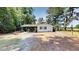 View of the house with white siding, carport, and a lawn at 4509 Stevens Chapel Rd, Smithfield, NC 27577