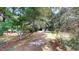 Secluded home surrounded by lush trees with a long driveway through the yard at 4509 Stevens Chapel Rd, Smithfield, NC 27577