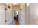Hallway featuring hardwood floors, doors, and access to other rooms in the home creating connectivity and flow at 4509 Stevens Chapel Rd, Smithfield, NC 27577