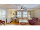 Comfortable living room with hardwood floors, a ceiling fan, and natural light from the surrounding windows at 4509 Stevens Chapel Rd, Smithfield, NC 27577