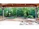 Covered patio offers view of lush backyard, with trees at 4509 Stevens Chapel Rd, Smithfield, NC 27577