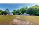 Large green field with multiple storage buildings and houses on property at 4509 Stevens Chapel Rd, Smithfield, NC 27577