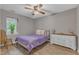Calm bedroom with hardwood floors, ceiling fan, dresser, and a window view at 501 Gooseneck Dr # B2, Cary, NC 27513