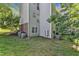 View of the building, with green lawn, partial brick facade, and several AC units at 501 Gooseneck Dr # B2, Cary, NC 27513