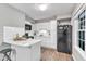 Modern kitchen with white cabinets, black appliances, and updated countertops at 501 Gooseneck Dr # B2, Cary, NC 27513