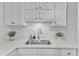 Close-up of the kitchen featuring a stainless steel sink and bright white cabinets at 501 Gooseneck Dr # B2, Cary, NC 27513