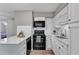Stylish kitchen with black appliances, white subway tile backsplash, and wood floors at 501 Gooseneck Dr # B2, Cary, NC 27513
