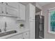Well-lit kitchen with white cabinetry, subway tile backsplash, and stainless steel sink at 501 Gooseneck Dr # B2, Cary, NC 27513
