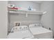 Laundry room includes a Whirlpool washer and dryer, with shelving for storage at 501 Gooseneck Dr # B2, Cary, NC 27513