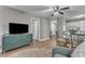 Spacious living room with hardwood floors, TV, and view of kitchen and bedroom at 501 Gooseneck Dr # B2, Cary, NC 27513