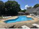 Community pool with lounge chairs and tables; perfect for relaxation and recreation at 501 Gooseneck Dr # B2, Cary, NC 27513