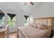 Bright bedroom featuring a large window, ceiling fan, and a spacious bed with neutral decor at 510 Berry Chase Way, Cary, NC 27519