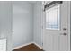 Bright entryway with hardwood floors, white door with a leaded glass window, and blue painted walls at 510 Berry Chase Way, Cary, NC 27519