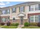 Inviting townhouse with neutral siding, brick accents, manicured bushes and contrasting shutters at 510 Berry Chase Way, Cary, NC 27519