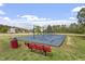 Community playground featuring swings, a safety surface, and a comfortable bench for relaxation at 510 Berry Chase Way, Cary, NC 27519