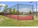 Community tennis court surrounded by a tall fence, offering a great space for recreational activities at 510 Berry Chase Way, Cary, NC 27519