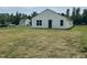 Spacious backyard featuring a white vinyl-sided home and lawn, offering a blank canvas for outdoor enjoyment at 5219 Merlin Dr, Snow Camp, NC 27349