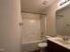 Bathroom featuring a shower-tub combo, modern toilet and sink with dark wood vanity at 5219 Merlin Dr, Snow Camp, NC 27349