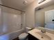Bathroom featuring a shower-tub combo, modern toilet and sink with dark wood vanity at 5219 Merlin Dr, Snow Camp, NC 27349