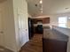 Open kitchen featuring modern appliances and an eat-in bar with a stainless steel sink at 5219 Merlin Dr, Snow Camp, NC 27349