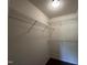 Walk-in closet with white walls and installed wire shelving for optimal organization at 5219 Merlin Dr, Snow Camp, NC 27349