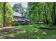 Spacious backyard featuring manicured lawn, landscaping, and a partial view of the rear of the home at 5304 W Oaks Dr, Fuquay Varina, NC 27526