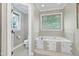Bathroom featuring a soaking tub, built-in storage, and natural light at 5304 W Oaks Dr, Fuquay Varina, NC 27526