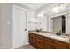 Bathroom featuring double vanity with granite countertop and wood cabinetry at 5304 W Oaks Dr, Fuquay Varina, NC 27526