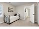Neutral bedroom featuring a single bed, carpeted floors, and access to additional rooms and closet space at 5304 W Oaks Dr, Fuquay Varina, NC 27526