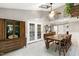 Bright dining room featuring tile floors, statement lighting, and french doors leading to the exterior at 5304 W Oaks Dr, Fuquay Varina, NC 27526