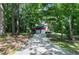 Exterior view of home featuring an extra long driveway, an attached two car garage, and wooded perimeter at 5304 W Oaks Dr, Fuquay Varina, NC 27526
